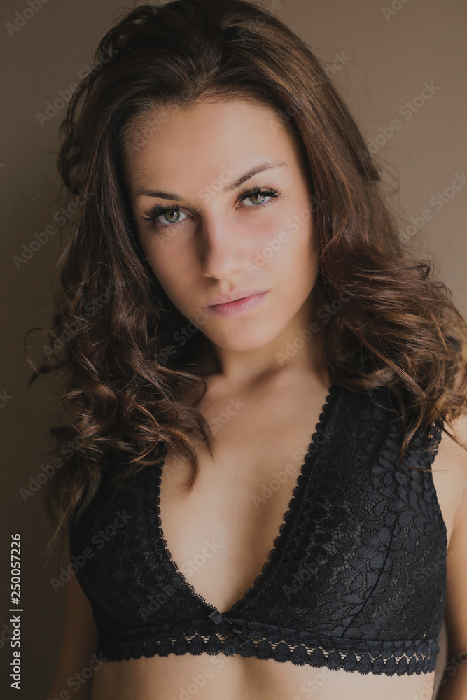 Beautiful brown-haired girl looking at camera at home Beautiful brown-haired girl looking at camera at home
