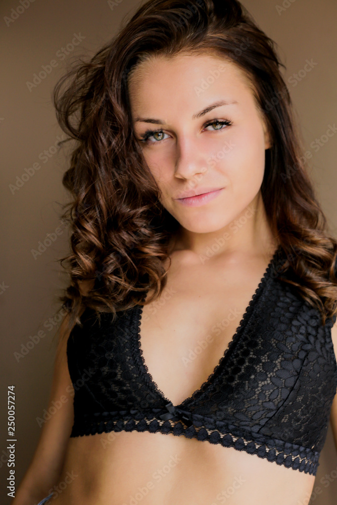 Beautiful brown-haired girl looking at camera at home Beautiful brown-haired girl looking at camera at home