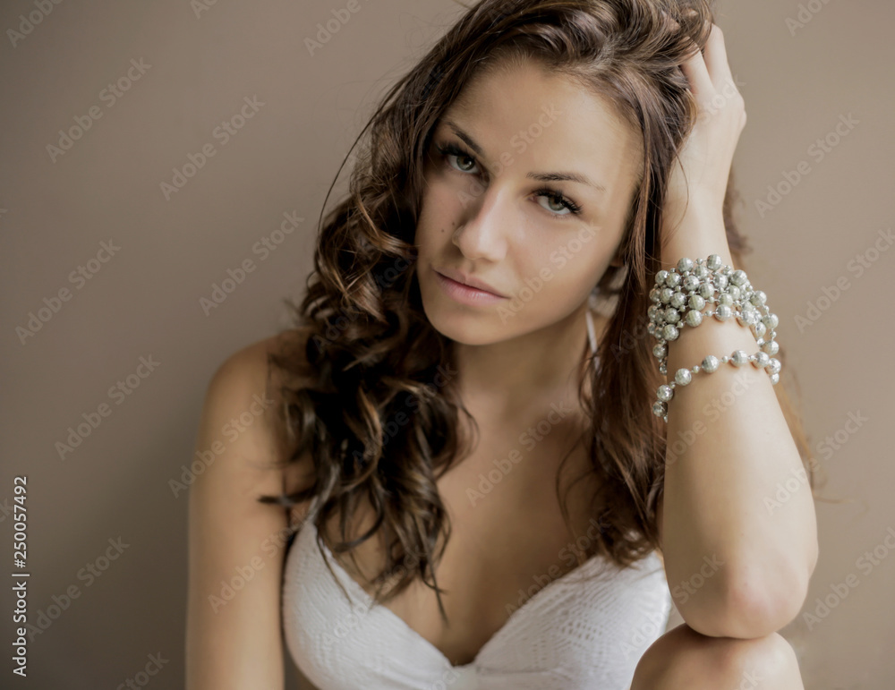 Beautiful brown-haired girl looking at camera at home Beautiful brown-haired girl looking at camera at home