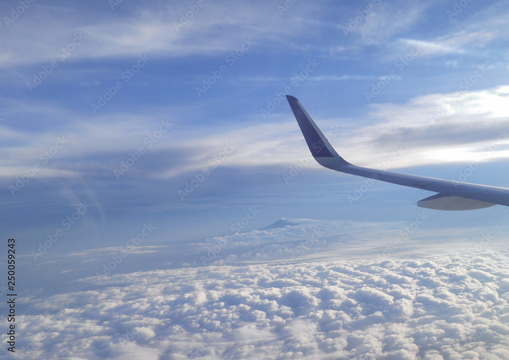 Airplane wing on the blue sky Airplane wing on the blue sky