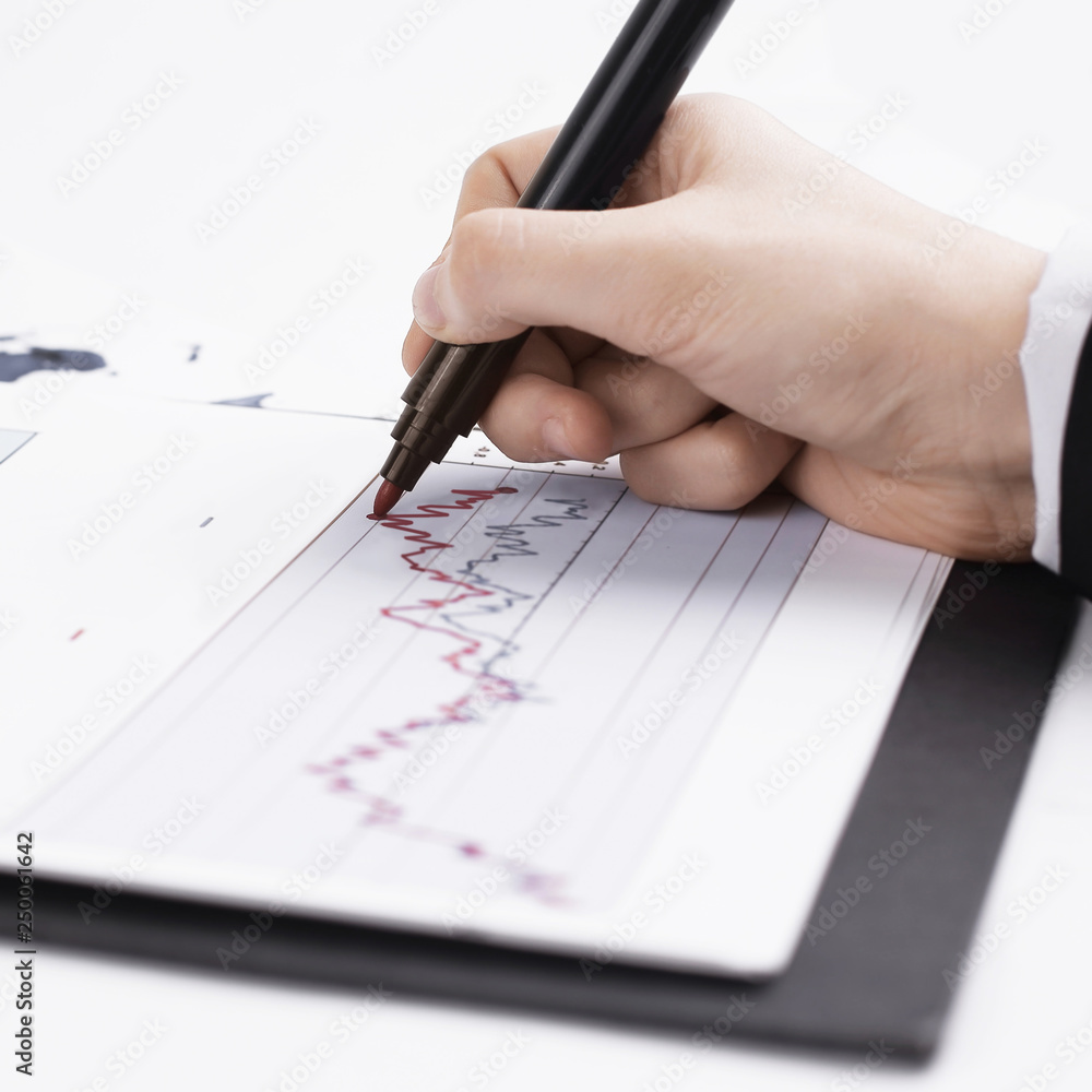 close-up. business woman working with a marketing schedule. close-up. business woman working with a marketing schedule.