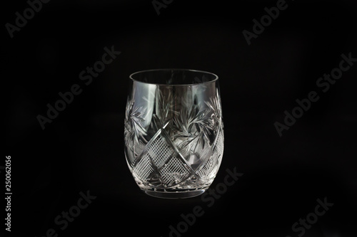 Vintage empty crystal glass on the black background.