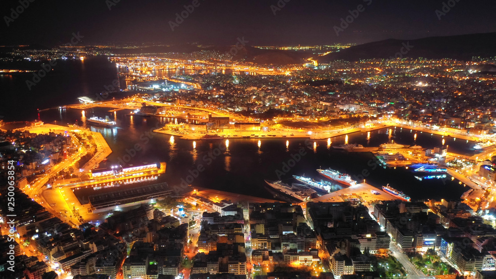 Aerial drone panoramic night shot of famous port of Piraeus one of the largest in Europe