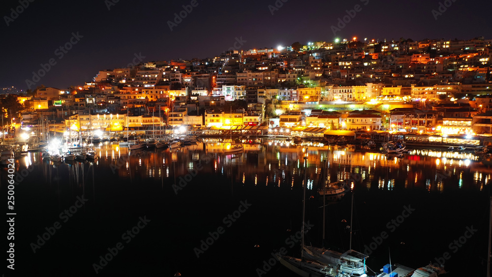 Aerial drone night shot of famous small safe port of Mikrolimano with sailboats docked, Piraeus, Attica, Greece