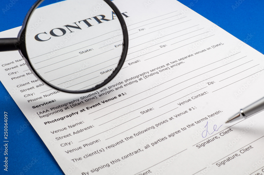 Magnifying glass and document contract close up Magnifying glass and document contract close up