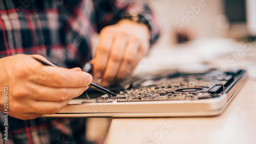 Electrician engineer technician repair faulty laptop computer in electr service