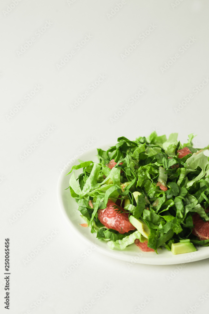 healthy vegan green salad in white bowl healthy vegan green salad in white bowl