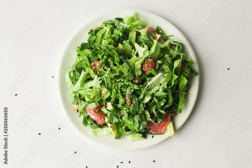 healthy vegan green salad in white bowl healthy vegan green salad in white bowl