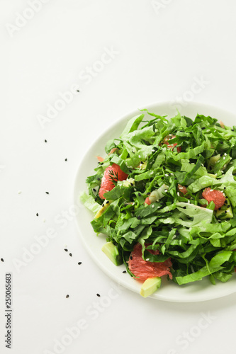 healthy vegan green salad in white bowl