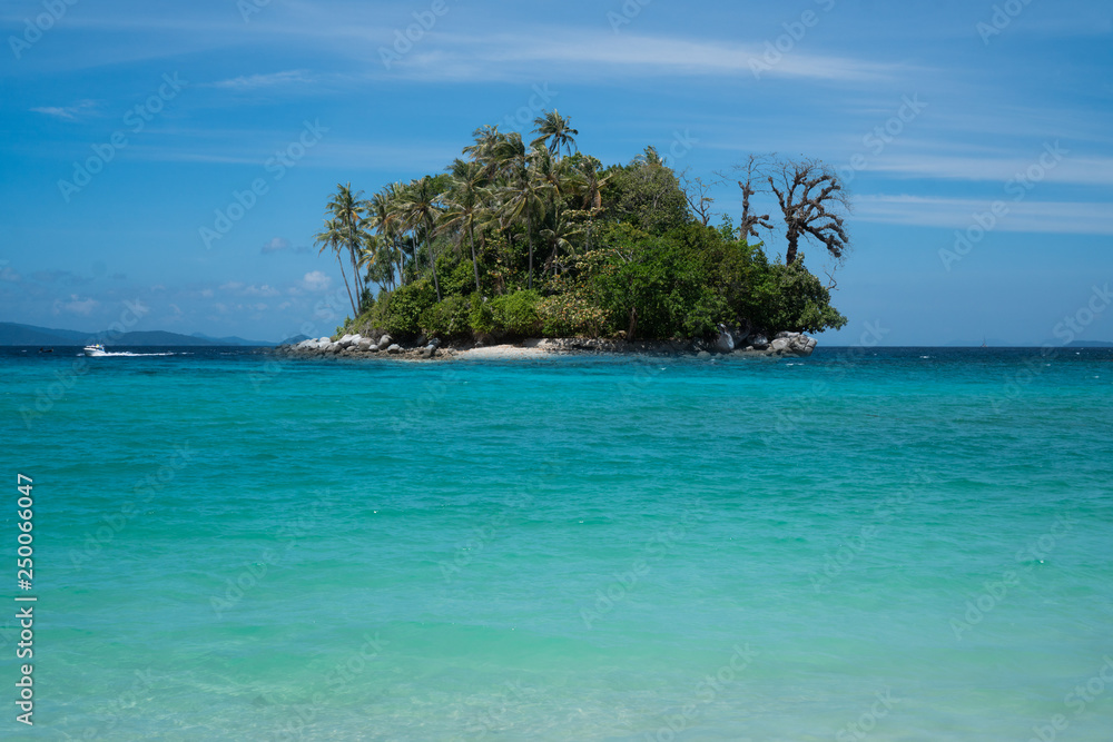 Fototapeta premium Seascape with small island over blue summer sky background. Paradise beach on small island