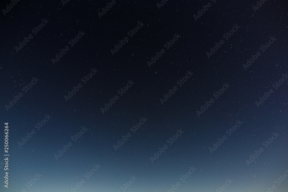 Fototapeta premium Stars in the night sky. Outer space background with the full moon photographed.