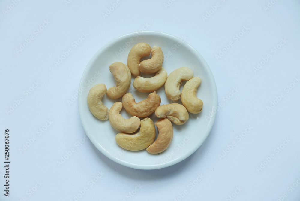 Top view of cashew nuts in bowl on white background. Top view of cashew nuts in bowl on white background.