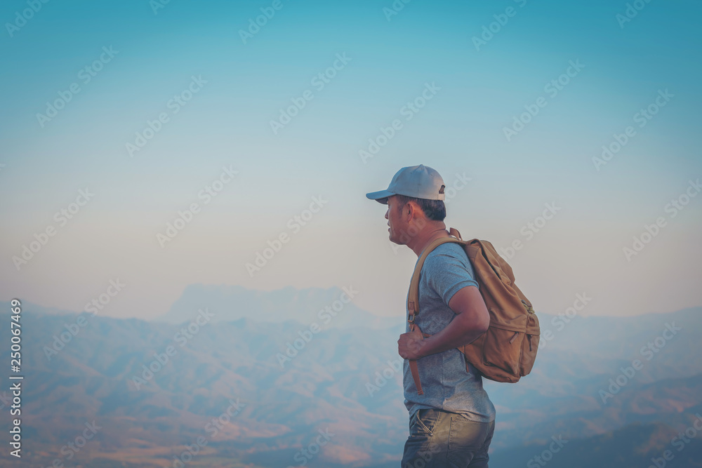 Young Man Traveler with map backpack relaxing outdoor with rocky mountains on background Summer vacations and Lifestyle hiking concept