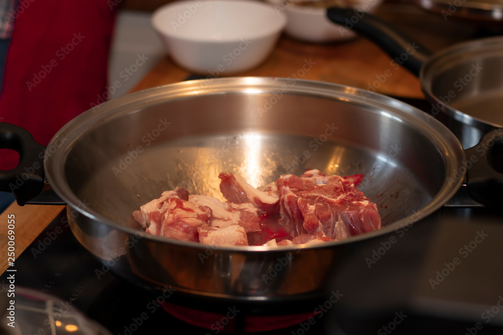 cook preparing lamb soup with vegetables in the kitchen cook preparing lamb soup with vegetables in the kitchen