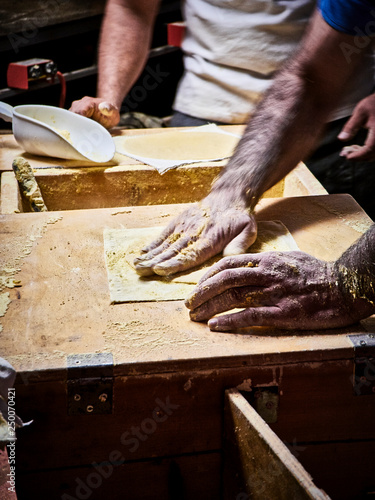 Two cooks making Tortillas on a wooden rustic table. photo