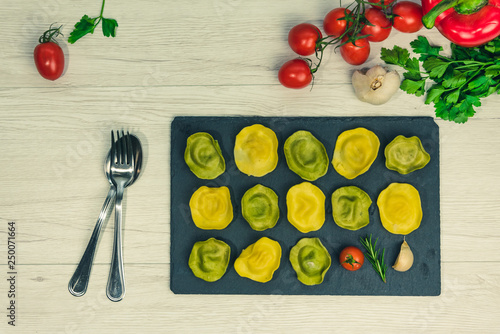 Classic ravioli filled with basilico and cheese on a platter of stone.