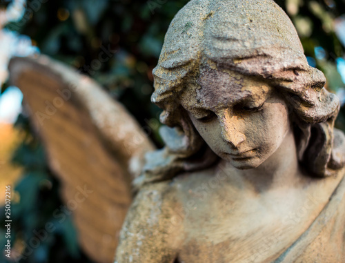 Picture of a sad angel close-up. Symbol of goodness  memory  help and love.