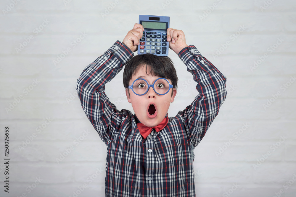 Happy student showing calculator over his head Happy student showing calculator over his head