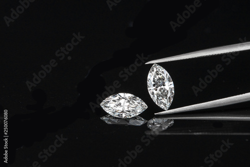 marquise diamond with tweezer on black background photo