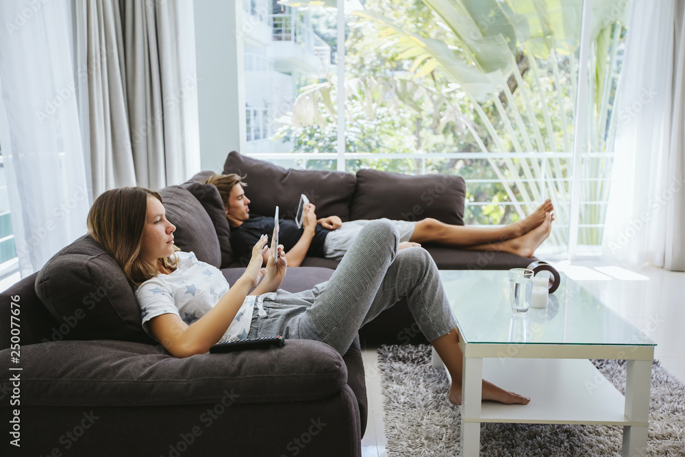 Teenagers using tablet pc on couch Teenagers using tablet pc on couch