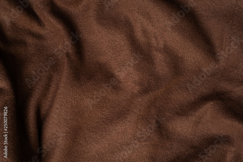 Colored textile background texture. Dark brown pattern
