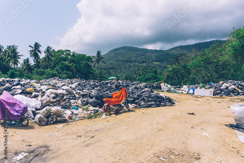 PLASTIC POLLUTION in the jungle. Dirty plastic bottles and bags on a garbage. Ocean pollution, plastic in water. Pollution and recycle eco concept