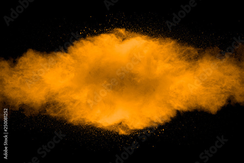 Abstract art orange powder on black background.