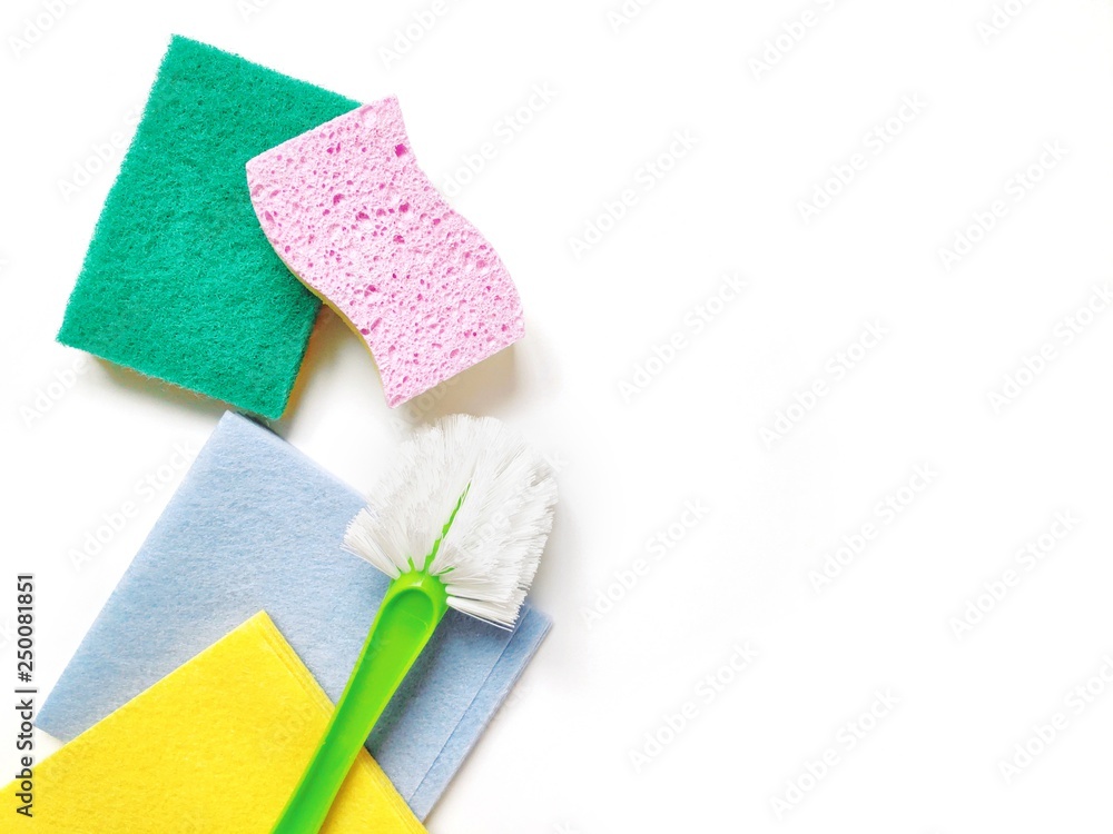 Green cloth, pink sponge, brush for professional home cleaning service. Flat lay photo, copy space Green cloth, pink sponge, brush for professional home cleaning service. Flat lay photo, copy space