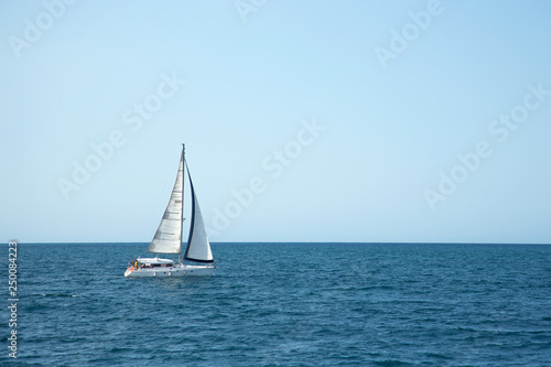 Sailboat sailing on the sea. Ship sailing in full sails on the sea. Yacht in the sea. © fortton