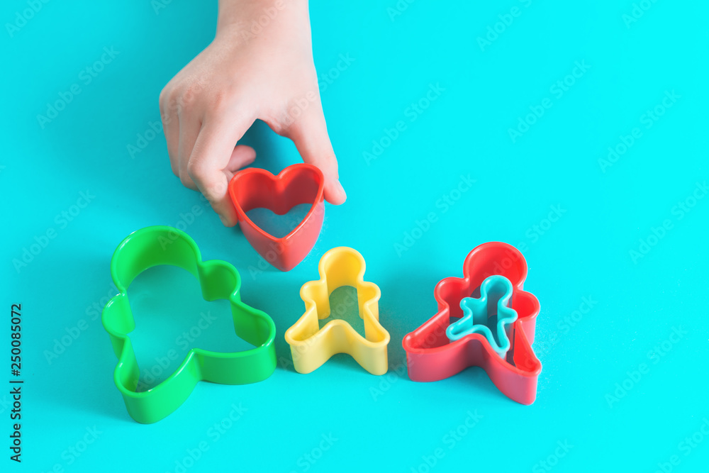 Happy family concept cut outs in hands of a child. Mother, father, son, daughter and pregnancy top view with copy space Happy family concept cut outs in hands of a child. Mother, father, son, daughter and pregnancy top view with copy space