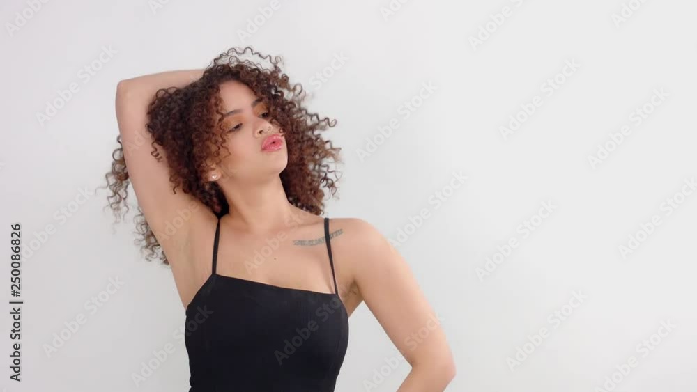 mixed race black woman with freckles poses to camera touches her hair makes faces. Natural meakup mixed race model mixed race black woman with freckles poses to camera touches her hair makes faces. Natural meakup mixed race model