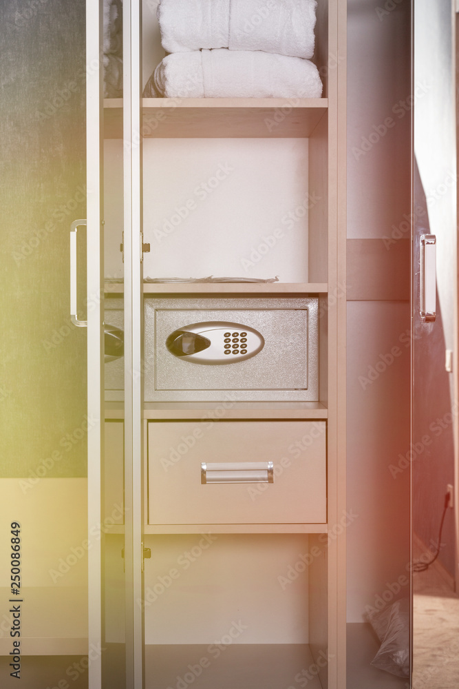 A wardrobe in the hotel room and a safe, bedroom interior. A wardrobe in the hotel room and a safe, bedroom interior.