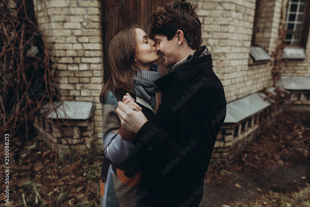 stylish man and woman kissing.romantic calm atmospheric moment. couple hugging gently in autumn park, showing true feelings. family togetherness concept