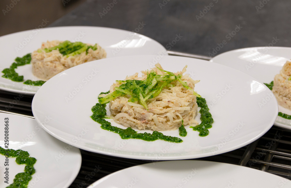 fish dish with spinach on a white plate fish dish with spinach on a white plate