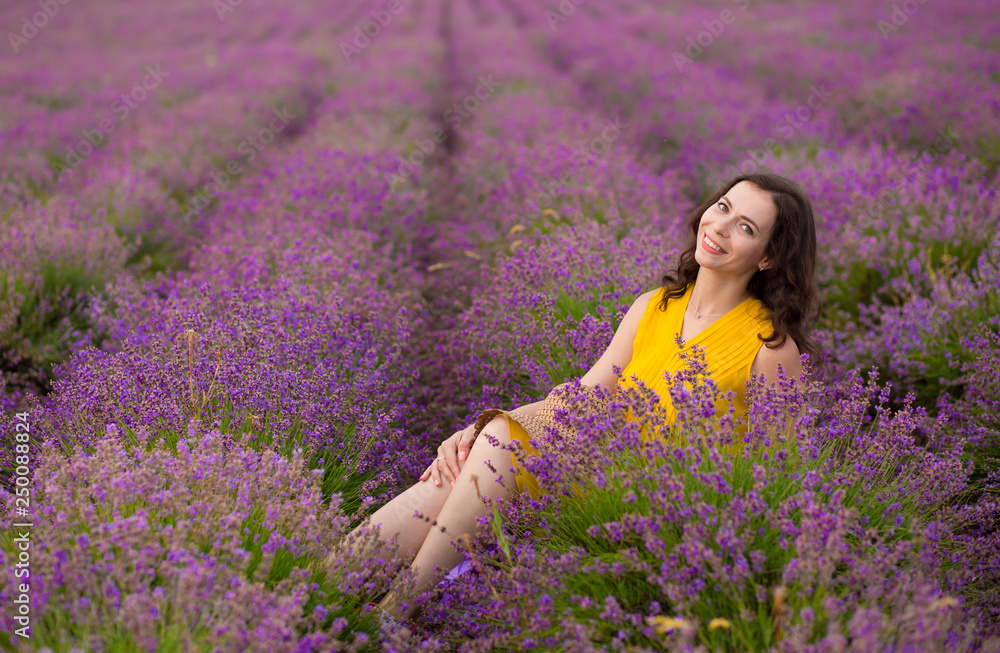 Beautiful young woman in yellow dress walking and having fun in purple flower lavander field. Beautiful young woman in yellow dress walking and having fun in purple flower lavander field.