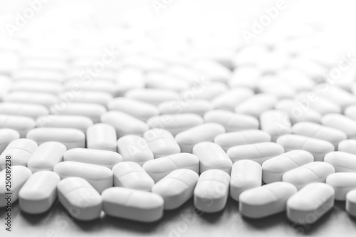 Background of white tablets on the table. Healthcare and medicine concept with copy space photo