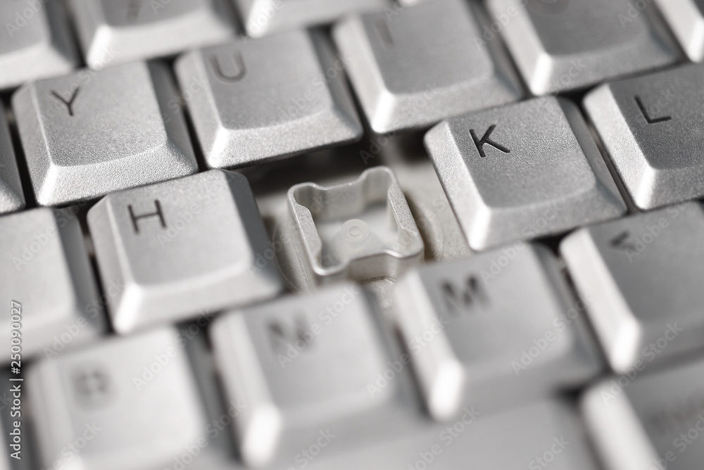 Broken button on a computer keyboard, close-up Broken button on a computer keyboard, close-up