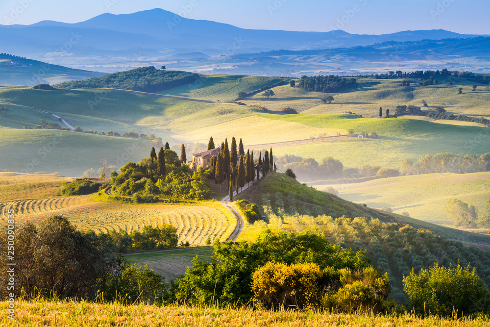 A lonely farmhouse between tuscan rolling hills. Val d'Orcia, Siena province, Tuscany, Italy