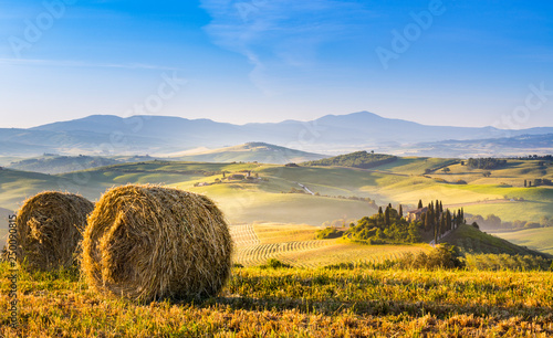 A lonely farmhouse between tuscan rolling hills. Val d'Orcia, Siena province, Tuscany, Italy