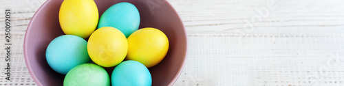 Colored eggs in a plate. The concept of Easter and spring.