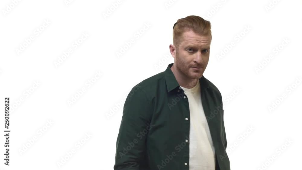 Slow motion handsome confident caucasian redhead masculine man walking along white background stop turning camera cross arms across chest confident smiling pleased, waiting action Slow motion handsome confident caucasian redhead masculine man walking along white background stop turning camera cross arms across chest confident smiling pleased, waiting action