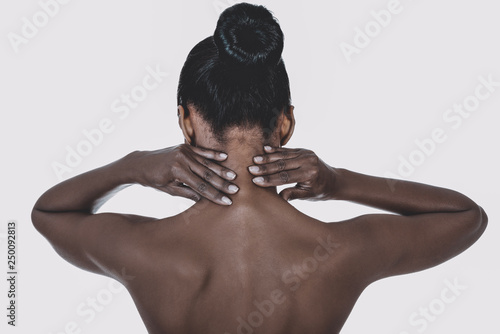 Black woman with neck pain. Head and shouders. Spine illness. photo