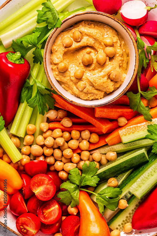Hummus with various fresh raw vegetables. Hummus with various fresh raw vegetables.