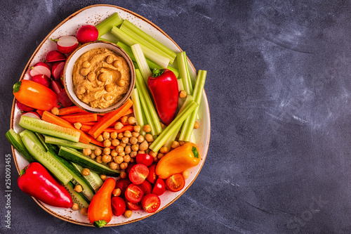 Hummus with various fresh raw vegetables. photo