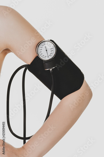 Woman arm with sphygmomanometer isolated on white background. photo