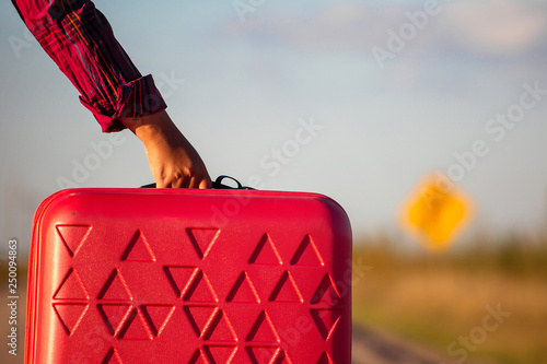 hand with a suitcase