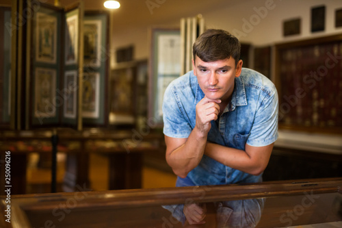 Man looking at stands with exhibits