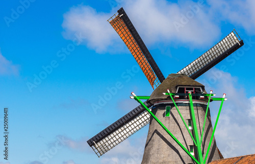 Windmill in agriculture farm with clear blue sky at Zaanse Schans landmark near Amsterdam, Netherland, Europe