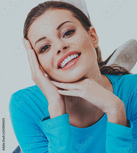 Portrait of smiling young woman, on white background.