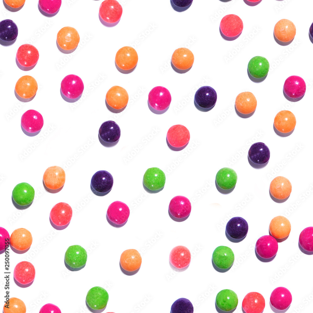 Colorful seamless texture pattern of multi colored sweet candy dragees. Round Bonbons scattered on a white background. Decorative Holiday Web banner. Beautiful Festive Wallpaper.